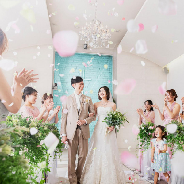 ゲストに囲まれフラワーシャワー、幸せいっぱいの新郎新婦