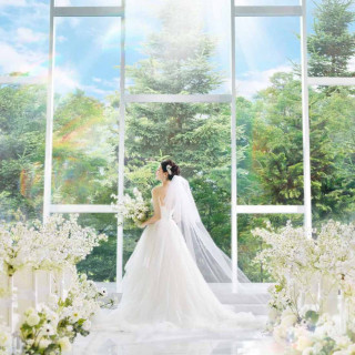空×緑×光あふれるリゾートチャペル。自然光が花嫁の表情とドレスを引き立てます。