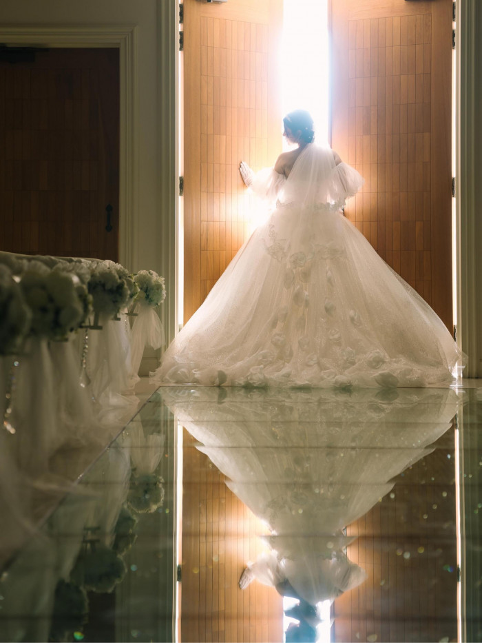 当館のチャペルは、煌めくガラスのバージンロードが魅力のひとつ。反射する花嫁姿が美しい