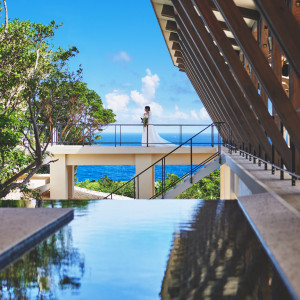 洗練されたデザインの館内にて美ら海が背景のフォトウェディング