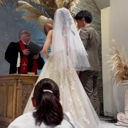 大好きなドライフラワーに囲まれた素敵なチャペルで誓いの紙にサインをしているシーンです！聖歌隊の生歌や生演奏の中で挙式を挙げられるのもアンジュガーデンの素敵なポイントです！