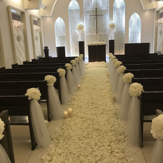 白を基調としたチャペル
下の花の絨毯と席の花はオプション