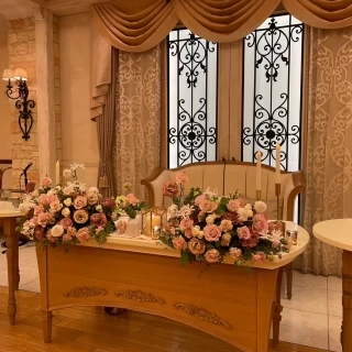 高砂の装花。色合いが落ち着いたピンクで会場の雰囲気と合う。